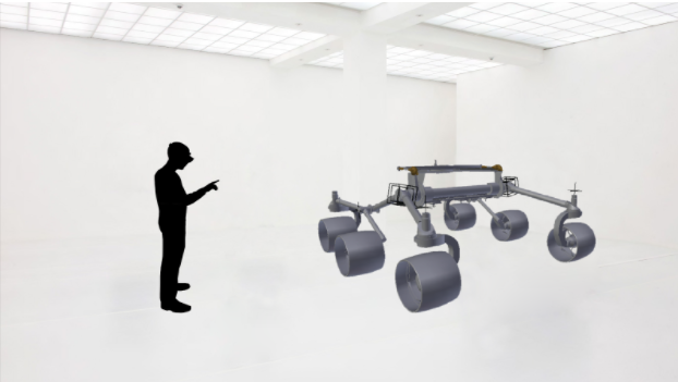 A person in a gallery space examining a 3D rover model through the HoloLens